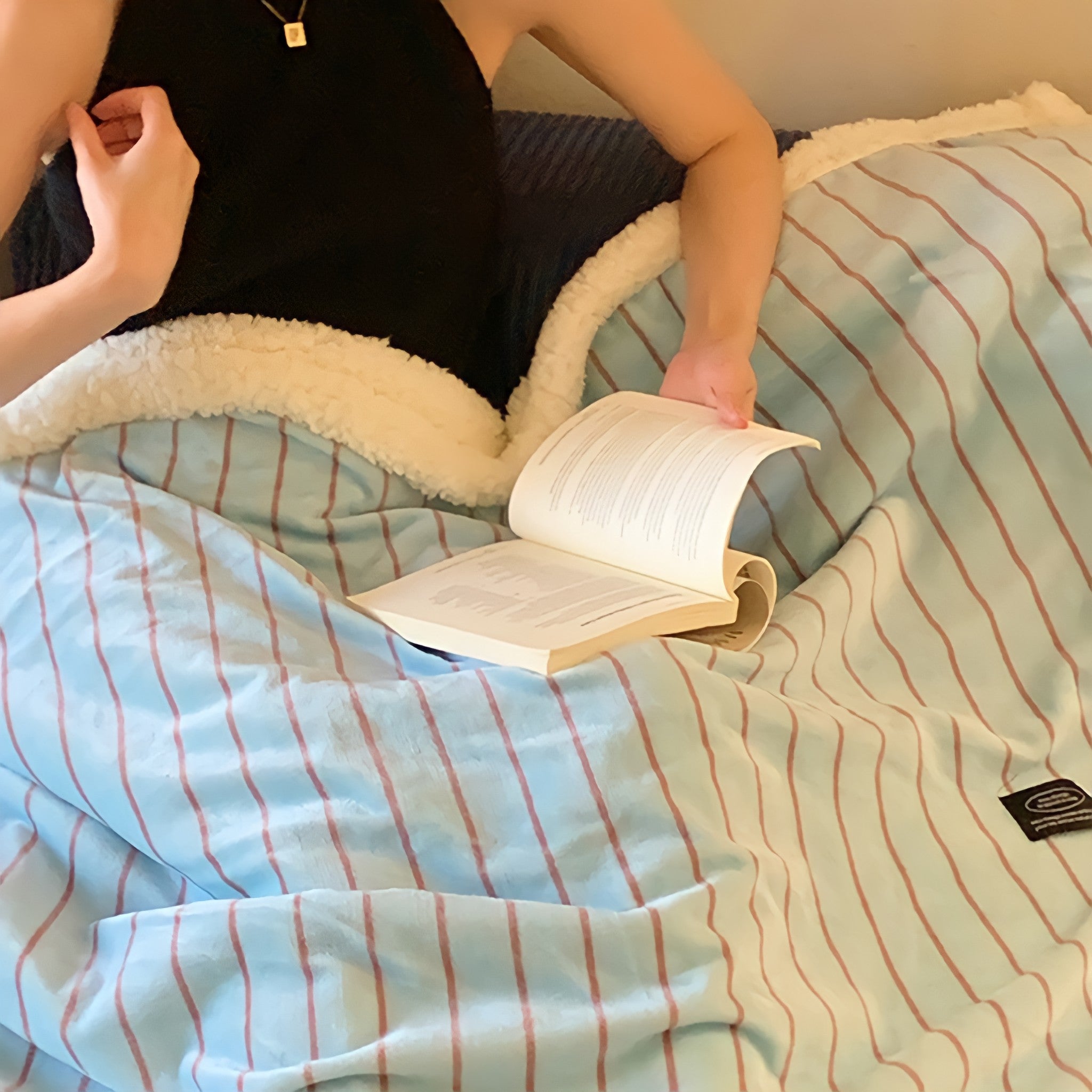 Striped fleece blanket in light blue