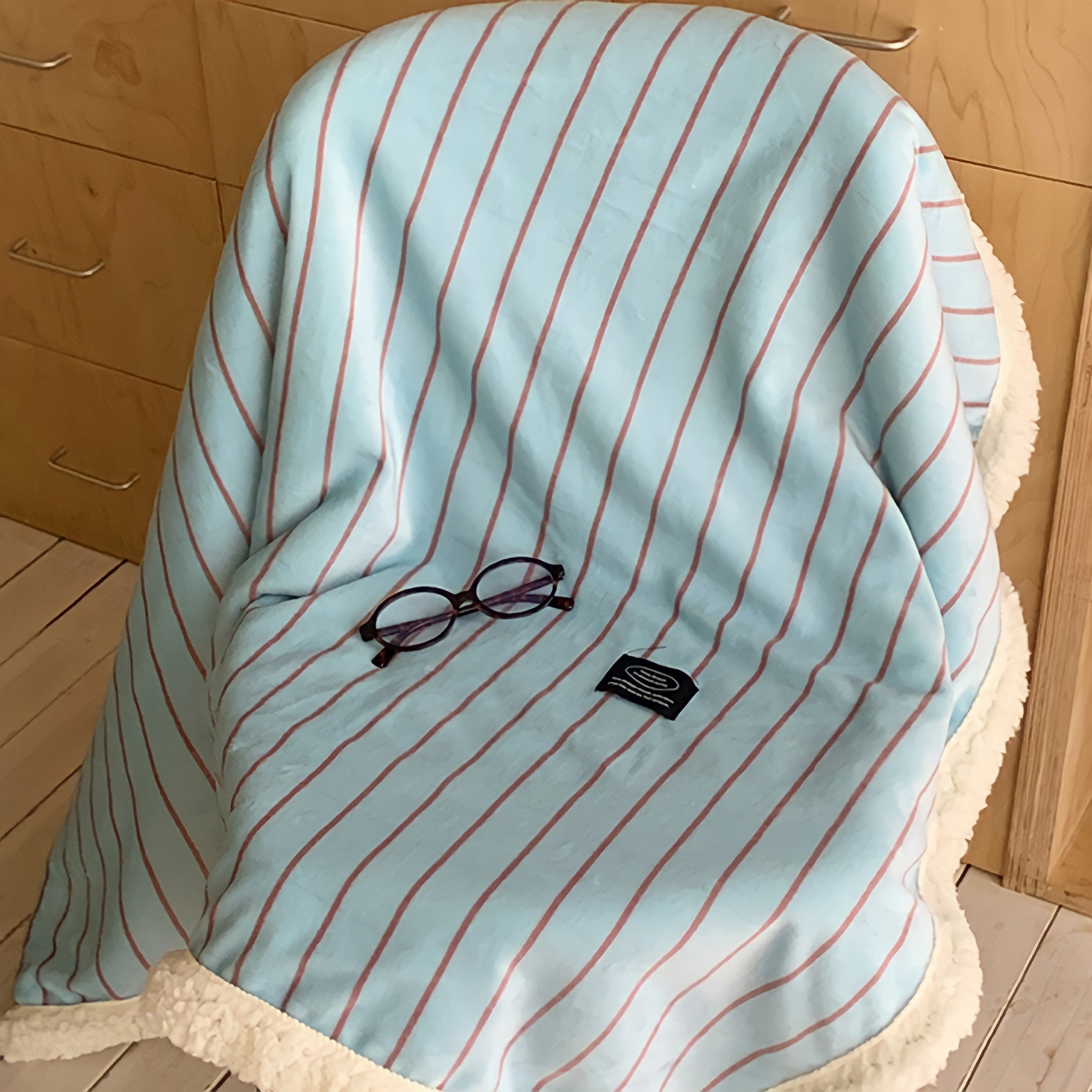 Striped fleece blanket in light blue