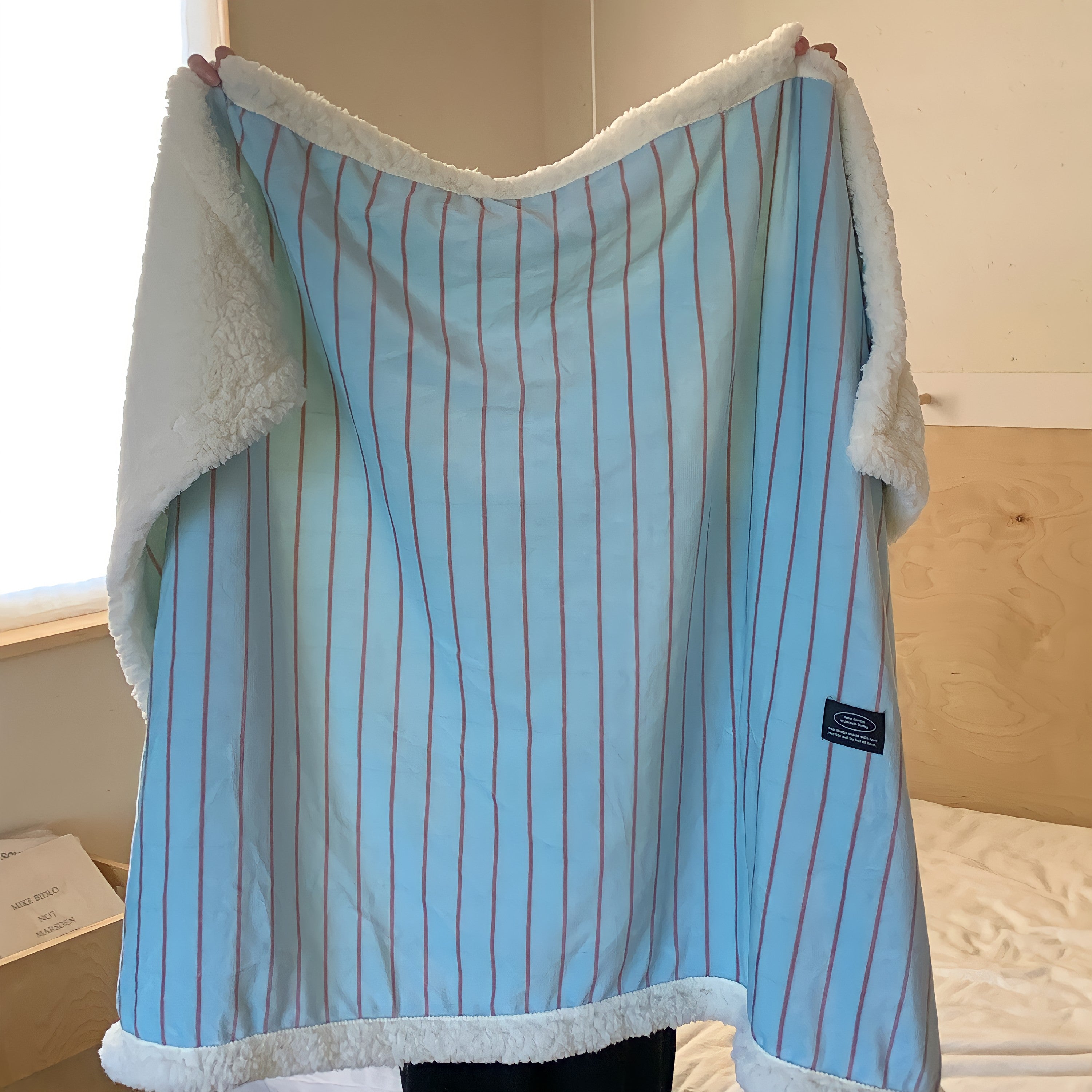 Striped fleece blanket in light blue