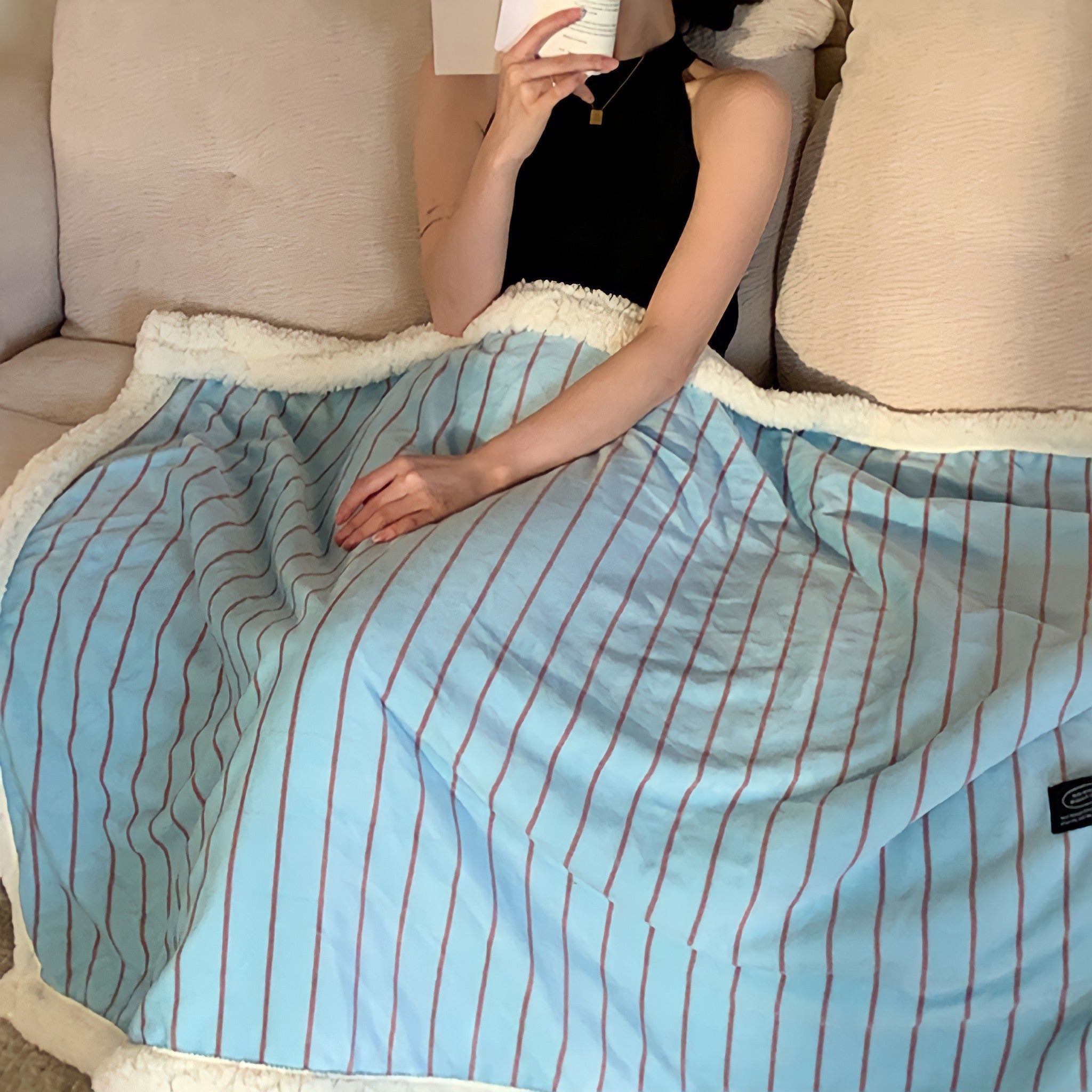 Striped fleece blanket in light blue